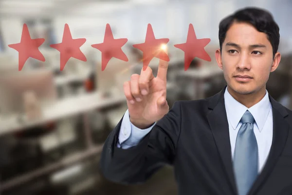 Stern asian businessman pointing — Stock Photo, Image