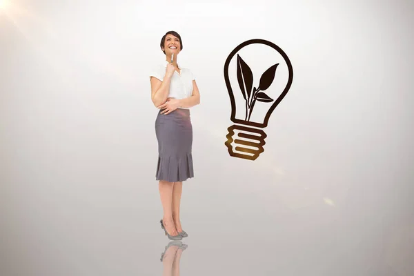 Thoughtful businesswoman against idea — Stock Photo, Image