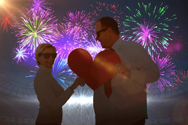 Couple holding red heart shape — Stock Photo, Image