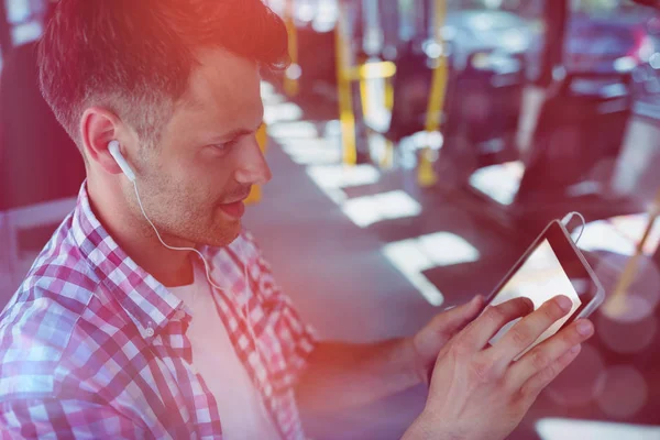 High angle view of handsome man listening music on digital tablet — Stock Photo, Image