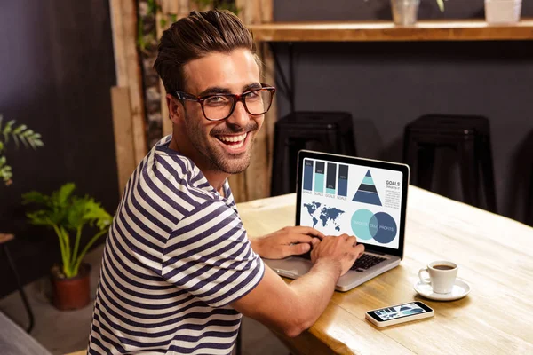 Happy man using laptop at cafe — Stock Photo, Image