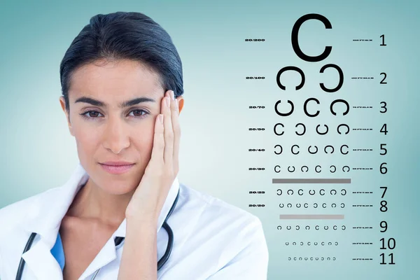 Imagen compuesta de retrato de hermoso médico con la cabeza en la mano —  Fotos de Stock