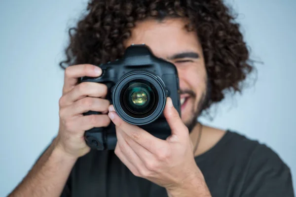 Photographer with digital camera in studio — Stock Photo, Image