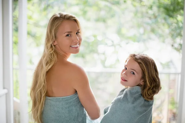 Smiling mother and daughter in towel at bathroom — Stock Photo, Image