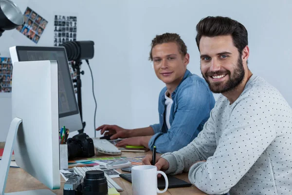 Fotógrafos trabajando juntos en el escritorio — Foto de Stock