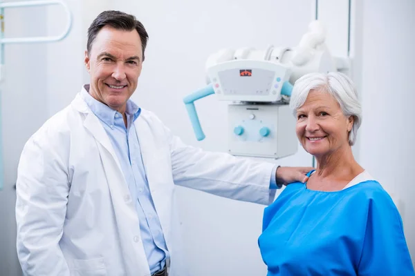 Portrait of smiling doctor and senior woman during medical check-up — Stock Photo, Image