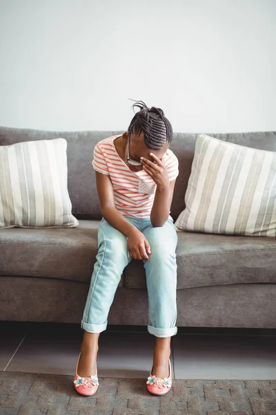 Menina perturbada sentada na cadeira no corredor — Fotografia de Stock