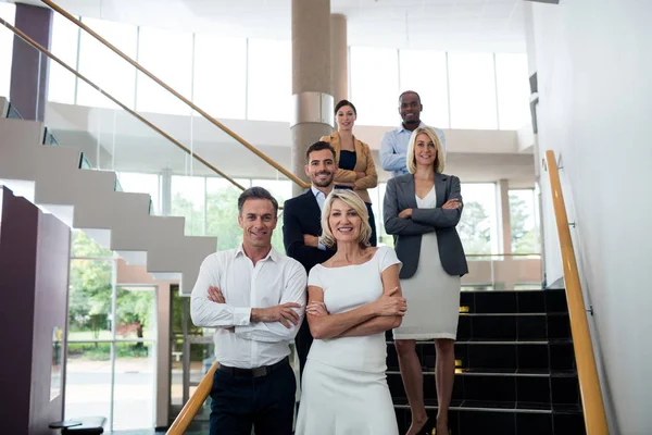 Business executives with arms crossed at conference center — Stock Photo, Image