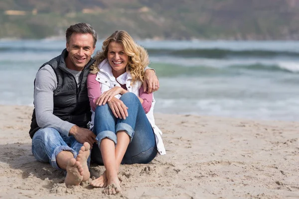 Pareja madura sentados juntos en la playa —  Fotos de Stock