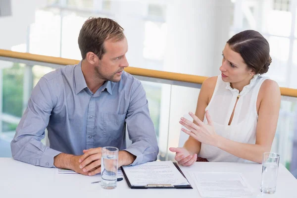 Businessman whispering something to his colleague — Stock Photo, Image