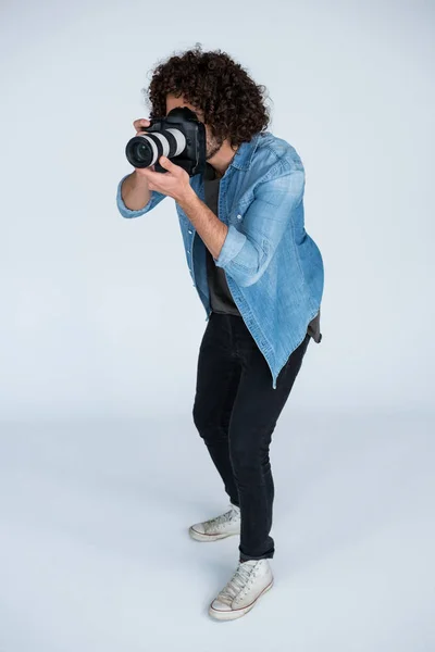 Photographer with digital camera in studio — Stock Photo, Image