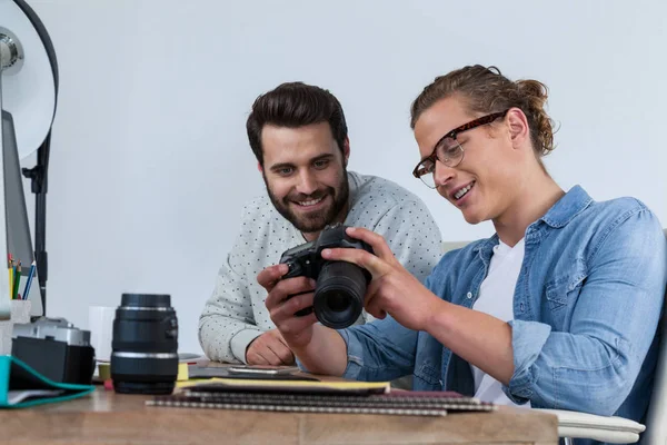 Photographers working together at the desk — Stock Photo, Image