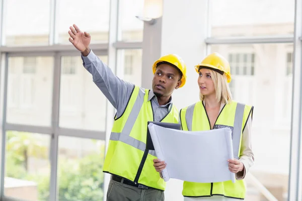 Architects discussing over blueprint — Stock Photo, Image