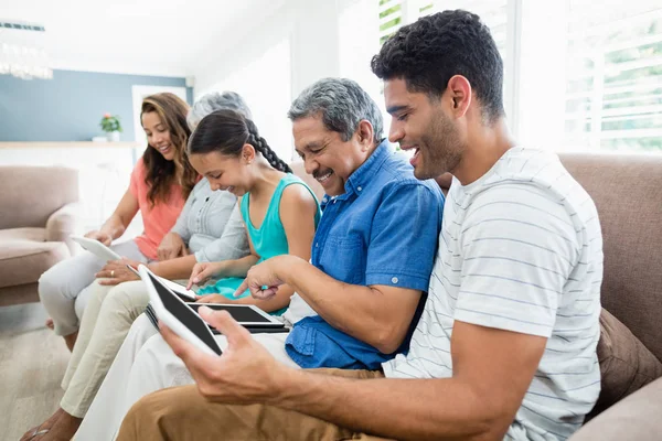 Multi-generation family using digital tablet in living room