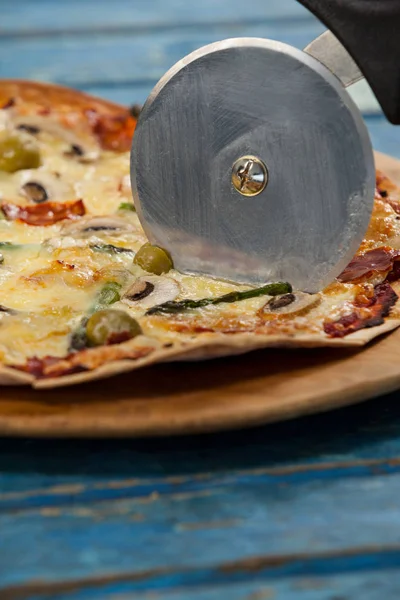 Heerlijke pizza geserveerd op pizza dienblad met kotterstag op pizza — Stockfoto