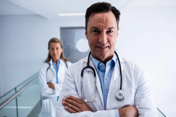Portrait of female and male doctor standing in the passageway — Stock Photo, Image