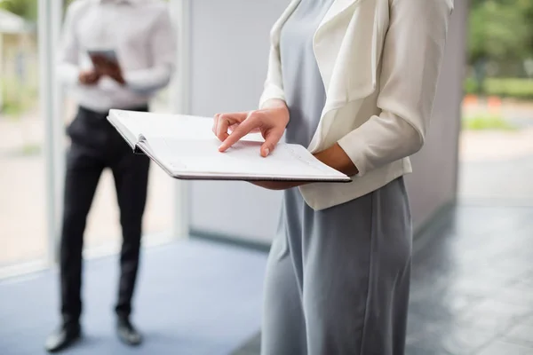 Businesswoman holding a file at conference centre — Stock Photo, Image