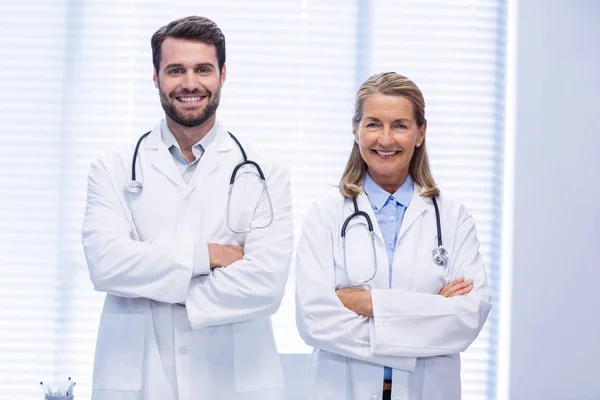 Portrait of doctors standing with arms crossed — Stock Photo, Image