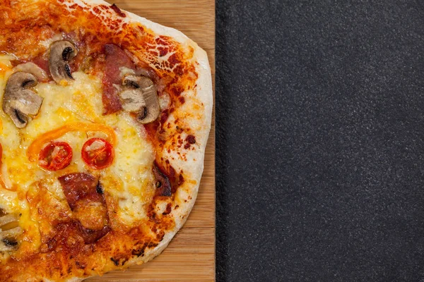 Delicious italian pizza served on wooden board — Stock Photo, Image