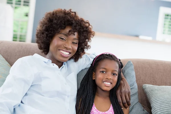 Porträt von Mutter und Tochter auf Sofa im Wohnzimmer — Stockfoto