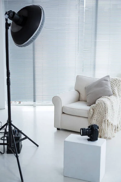 Armchair and spotlight in photostudio — Stock Photo, Image