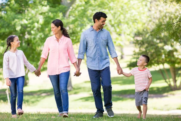 Happy family enjoying together in park — Stock Photo, Image