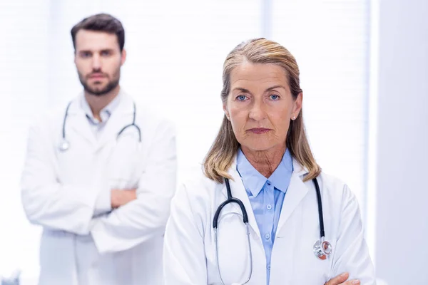 Portrait of doctors standing with arms crossed — Stock Photo, Image