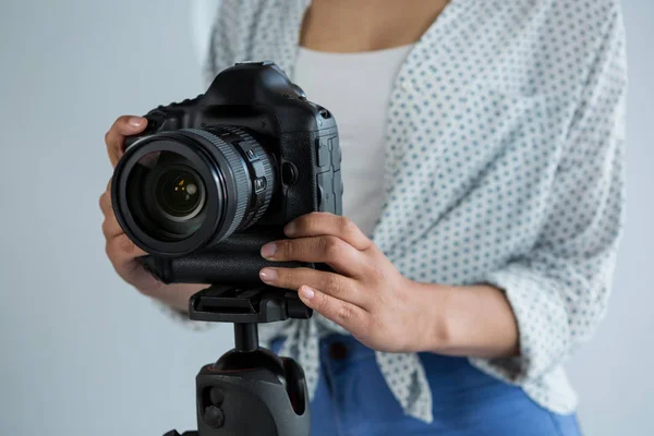 Photographer adjusting digital camera — Stock Photo, Image