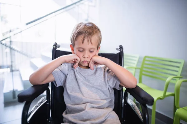 Sad boy patient sitting on a wheelchair — Stock Photo, Image