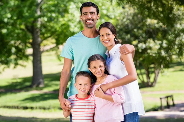 Retrato de família feliz em pé no parque — Fotografia de Stock