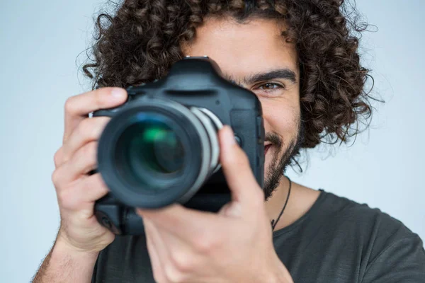 Photographer with digital camera in studio — Stock Photo, Image
