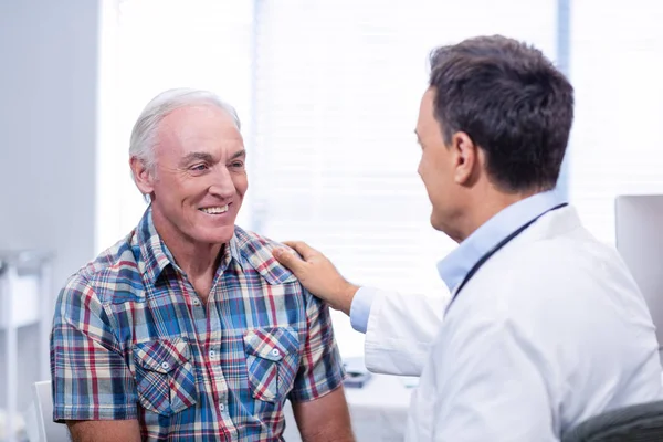 Läkare tröstande senior mannen — Stockfoto