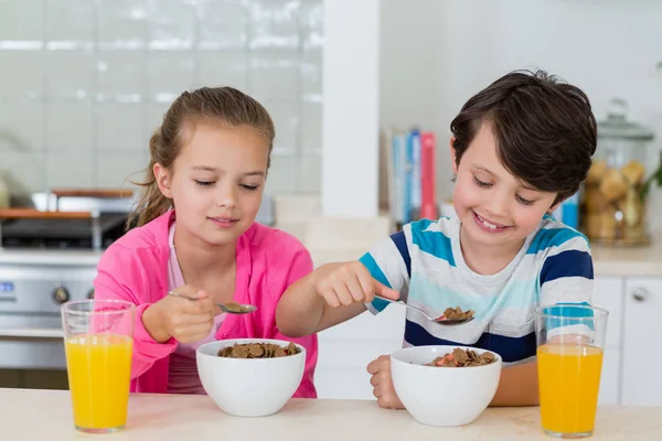 Siblings having a breakfast in kitchen — Stock Photo, Image