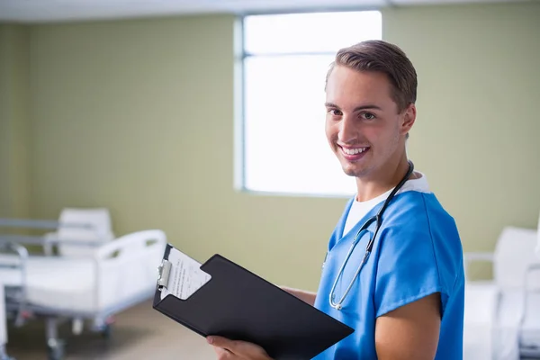 Portrait of doctor writing on clipboard — Stock Photo, Image