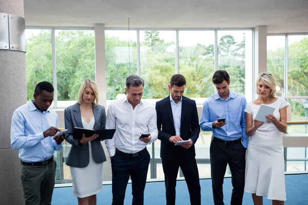 Dirigenti aziendali che utilizzano tablet digitale e telefono cellulare — Foto Stock