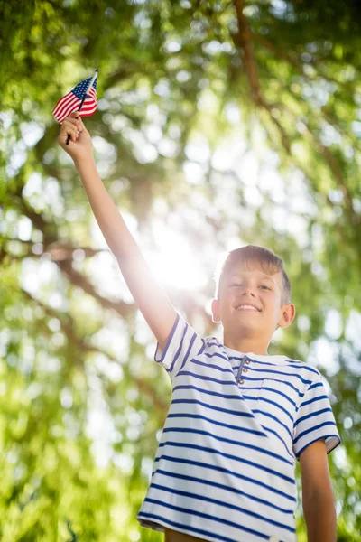 Niño sosteniendo pequeña bandera americana — Foto de Stock