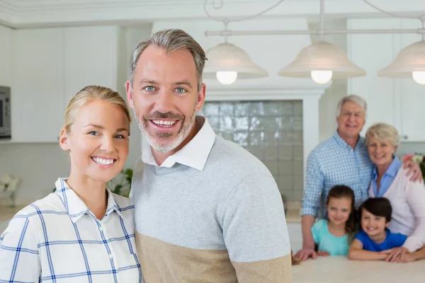 Portrait of happy couple standing at kitchen — Stock Photo, Image