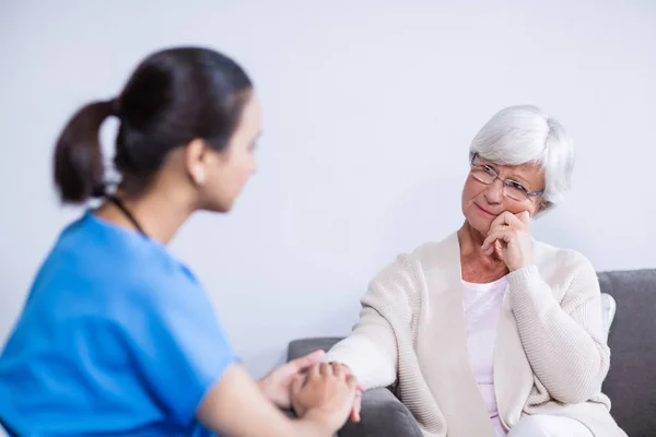 Doctor consoling senior patient — Stock Photo, Image