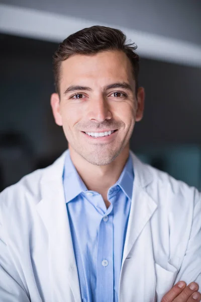 Portrait of smiling doctor standing with arms crossed — Stock Photo, Image