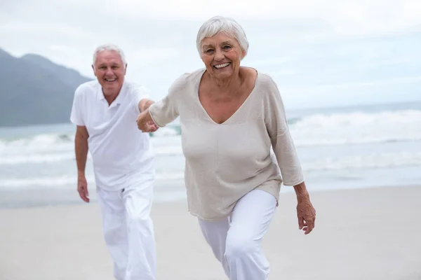 Senior couple having fun together at beach — Stock Photo, Image