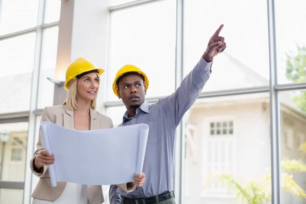 Architects discussing over blueprint — Stock Photo, Image