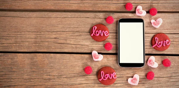 Amore dolci intorno smartphone — Foto Stock