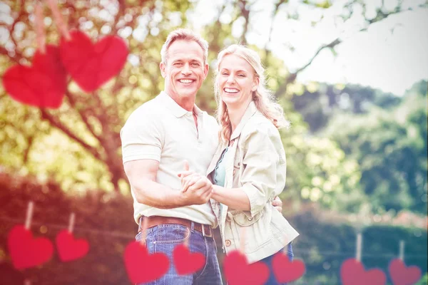 Couple holding hands against trees — Stock Photo, Image