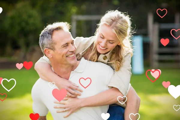 Husband giving piggy back to wife — Stock Photo, Image