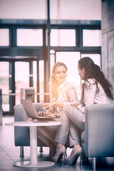 Businesswomen using laptop and having discussion — Stock Photo, Image