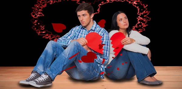 Dvojice sedící na podlaze s zlomené srdce — Stock fotografie