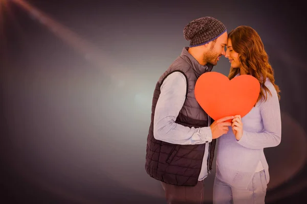 Couple holding heart shape paper — Stock Photo, Image