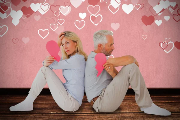 Unhappy couple holding broken heart Royalty Free Stock Images