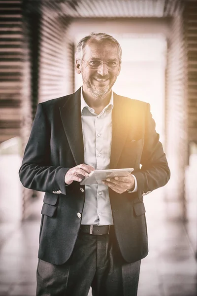 Cheerful businessman holding digital tablet — Stock Photo, Image