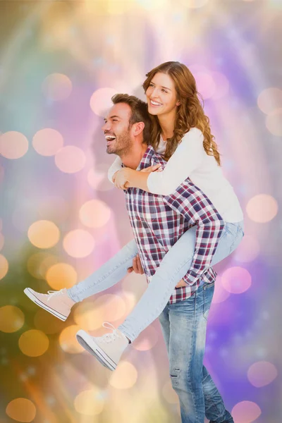 Man giving piggyback ride to woman — Stock Photo, Image